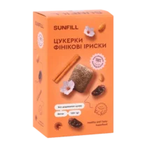 Orange Sunfill box with Ukrainian text, showing date-fudge candies, cinnamon sticks, flowers, and nuts; labels highlight no added sugar and healthy, natural snack.