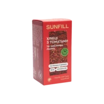 Упаковка хлібців Sunfill з томатами та насінням льону, червоно-рожевий дизайн з українським текстом на передній частині.