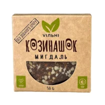 Cardboard box packaging for almond granola with a window showing mixed nuts; vegan and raw branding in Cyrillic text.