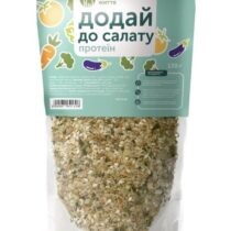 Turquoise bag of a seed-and-grain salad topper labeled 'додай до салату протеїн' with vegetable illustrations and sesame seeds visible through the lower packaging area.