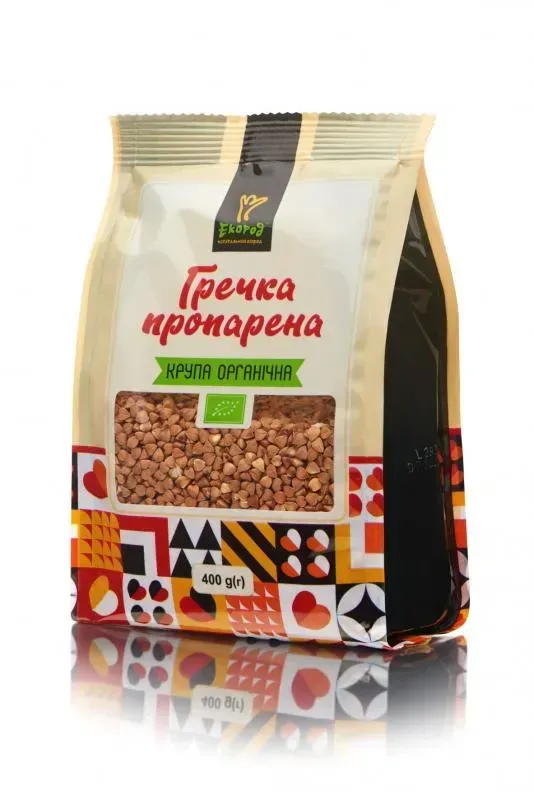 35972184720220 - MotherFarm bag of parboiled buckwheat groats in a beige package with a transparent window showing groats, green organic banner, and colorful geometric bottom patterns. інтернет-магазин молочних і натуральних продуктів