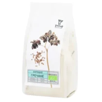 White bag of organic buckwheat groats with a plant illustration on the label and blue/green product branding on the front.